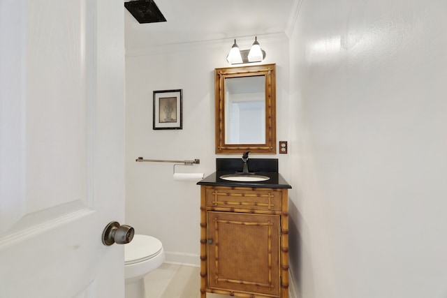 bathroom featuring vanity, ornamental molding, and toilet