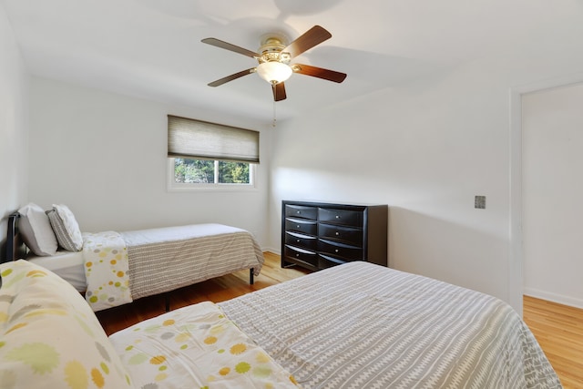 bedroom with ceiling fan and hardwood / wood-style flooring