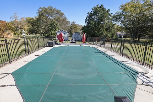 view of swimming pool with a lawn