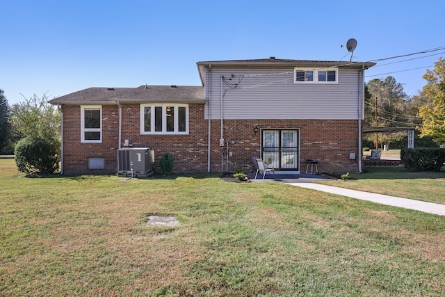 rear view of house with a yard and central AC