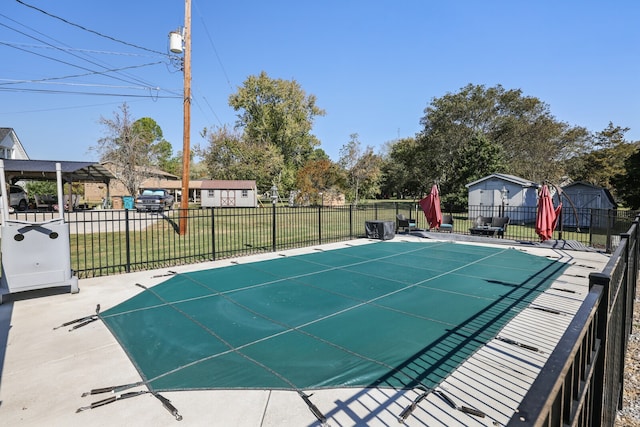 view of pool with a yard