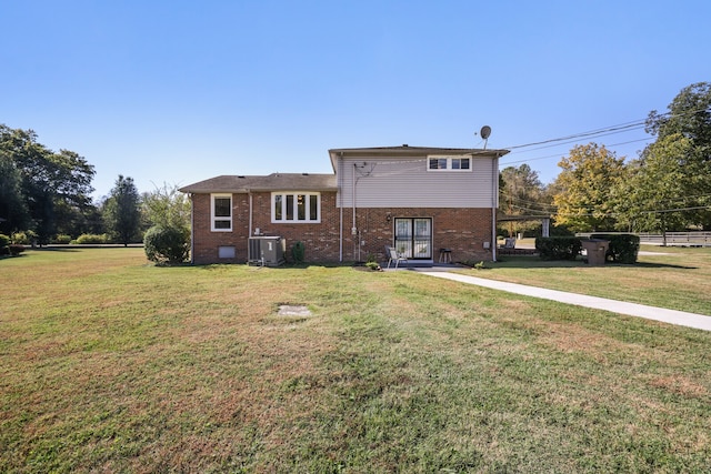 back of property featuring cooling unit and a lawn