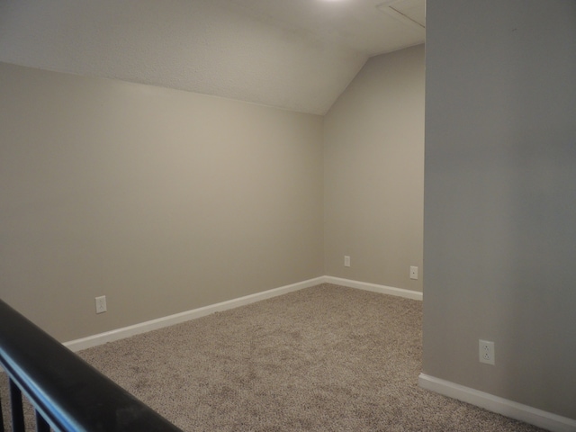 additional living space with carpet floors and vaulted ceiling