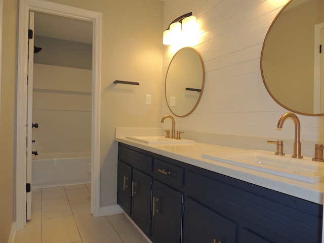 full bathroom featuring vanity, toilet, tile patterned floors, and washtub / shower combination