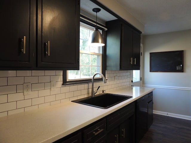 kitchen with sink, tasteful backsplash, a wealth of natural light, and pendant lighting