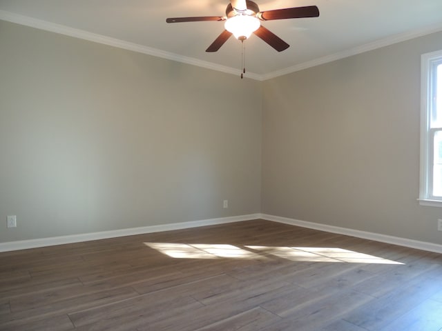 empty room featuring ornamental molding, ceiling fan, and dark hardwood / wood-style flooring