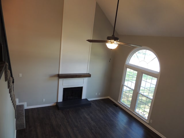 unfurnished living room with ceiling fan, high vaulted ceiling, and dark hardwood / wood-style flooring