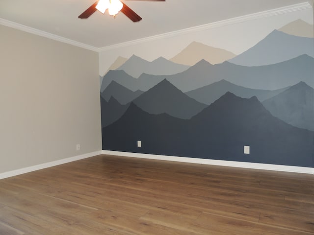 spare room with crown molding, wood-type flooring, and ceiling fan