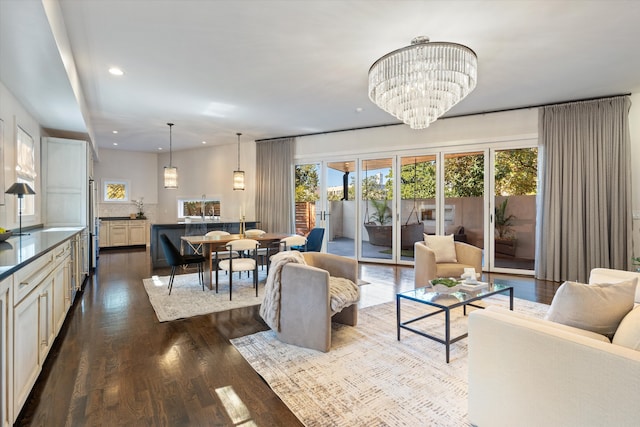 living room with a chandelier and dark hardwood / wood-style flooring