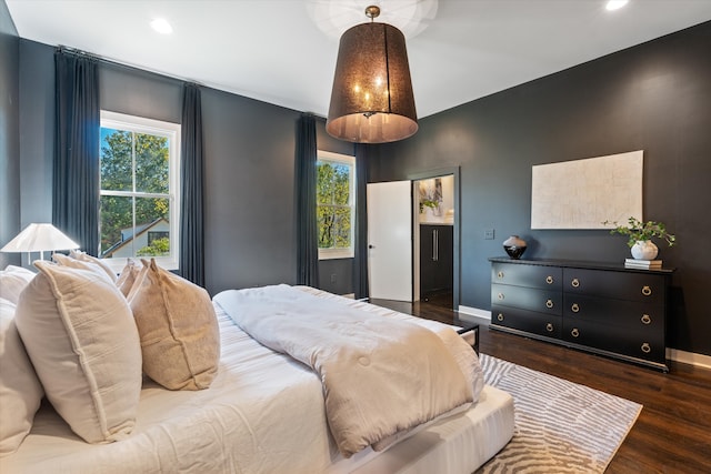 bedroom featuring dark wood-type flooring and multiple windows