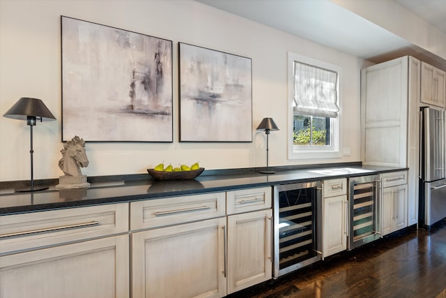 bar with dark hardwood / wood-style flooring, beverage cooler, and stainless steel refrigerator