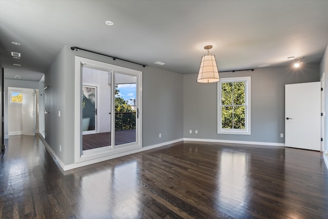 unfurnished room with dark wood-type flooring