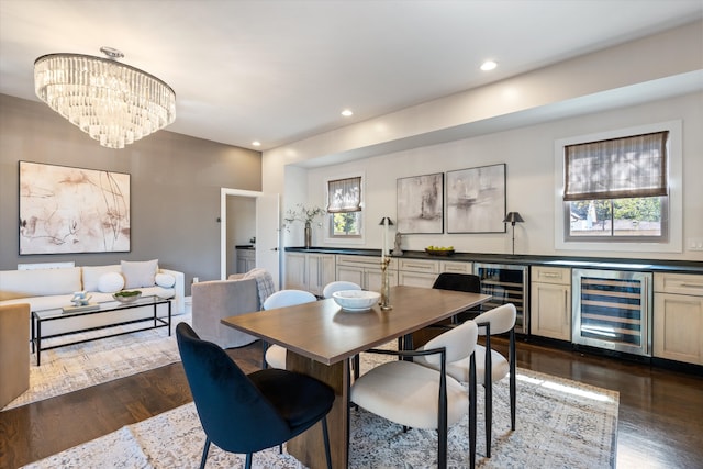 dining area featuring dark wood-type flooring, a healthy amount of sunlight, and beverage cooler