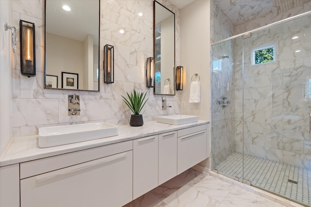 bathroom featuring tile walls, vanity, decorative backsplash, and a shower with shower door