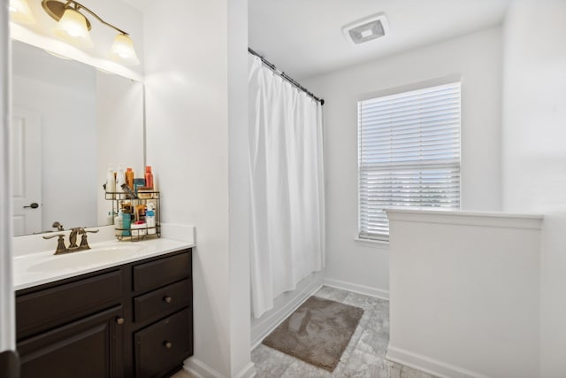 bathroom featuring vanity and a shower with shower curtain