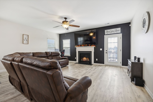 living room featuring light wood-type flooring and ceiling fan