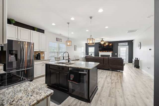 kitchen with sink, white cabinetry, stainless steel appliances, and plenty of natural light