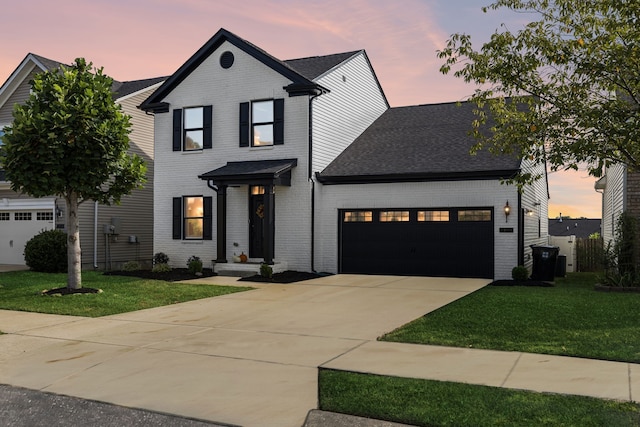 view of front facade featuring a yard and a garage