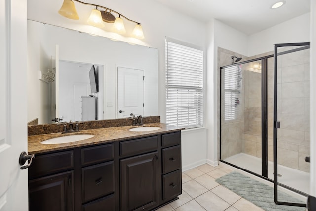 bathroom featuring vanity, tile patterned floors, and a shower with shower door