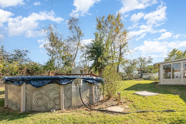 view of yard with a covered pool