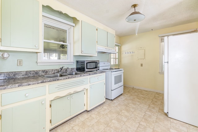 kitchen featuring a textured ceiling, sink, and white appliances