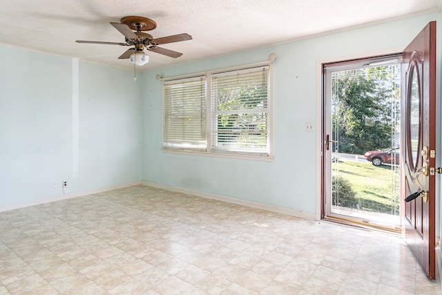 spare room featuring ceiling fan and a textured ceiling