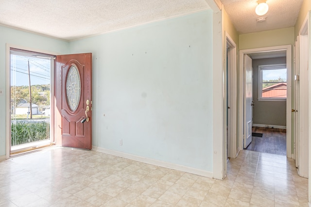 entryway featuring a textured ceiling and a healthy amount of sunlight