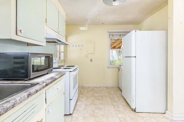 kitchen featuring white cabinetry, a textured ceiling, and white appliances