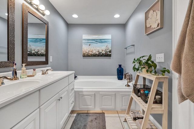 bathroom with vanity, tile patterned floors, and a washtub