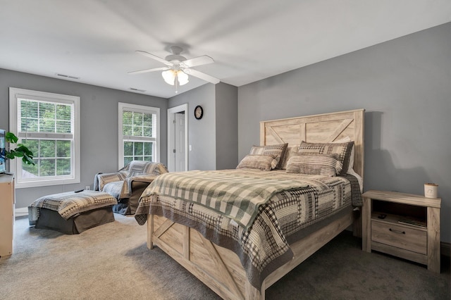 bedroom featuring ceiling fan and dark carpet