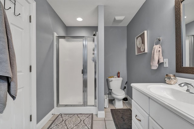 bathroom with vanity, tile patterned flooring, toilet, and walk in shower