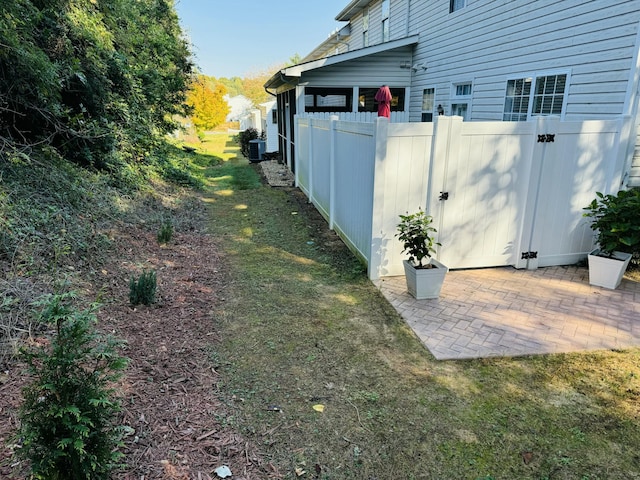 view of yard with a patio area and central AC unit