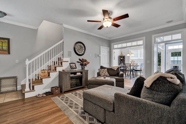 living room with ceiling fan, crown molding, and hardwood / wood-style floors