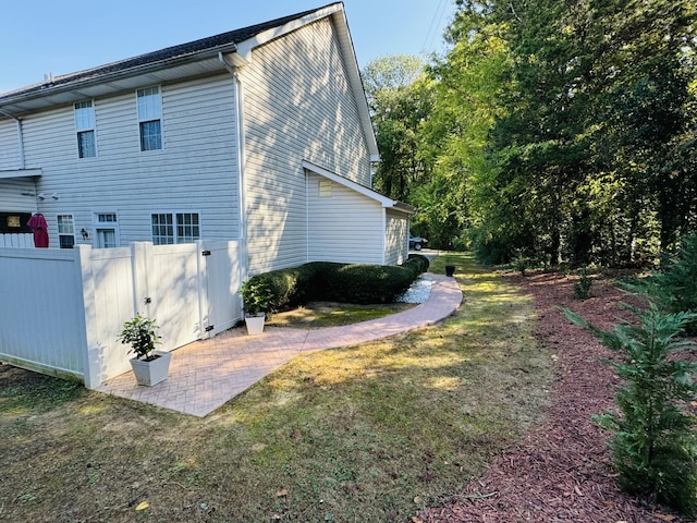 view of side of property featuring a yard