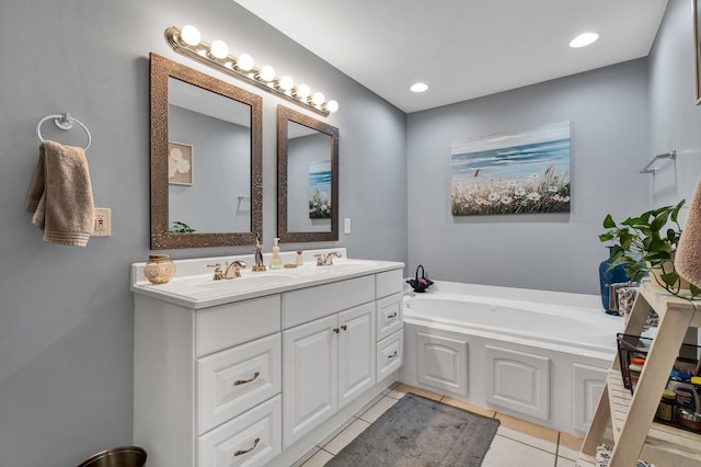 bathroom with vanity, a tub, and tile patterned floors