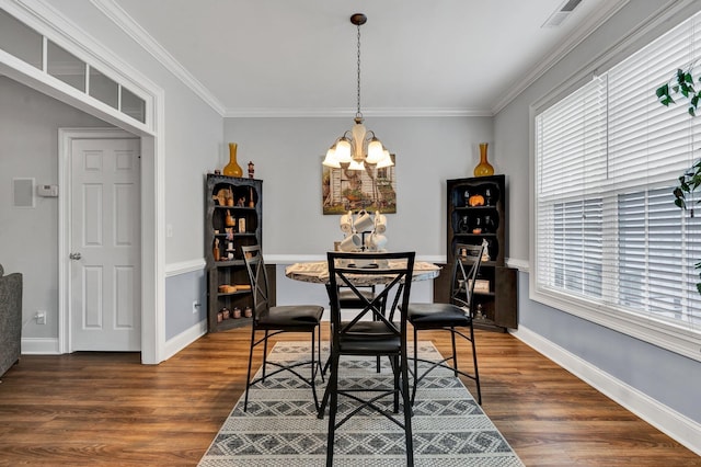 dining area with crown molding, dark wood-type flooring, and a wealth of natural light