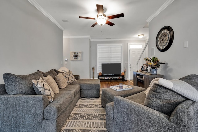 living room featuring ornamental molding, wood-type flooring, and ceiling fan