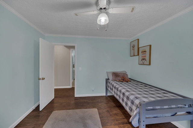 bedroom featuring ornamental molding, a textured ceiling, dark wood-type flooring, and ceiling fan