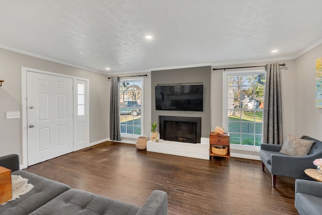 living room with plenty of natural light, a textured ceiling, and dark hardwood / wood-style floors