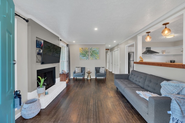 living room with a textured ceiling, dark hardwood / wood-style floors, and crown molding