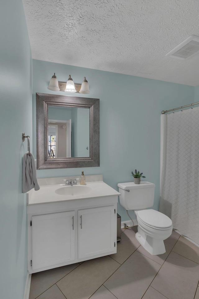 bathroom with walk in shower, tile patterned flooring, a textured ceiling, vanity, and toilet