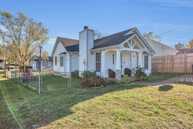 rear view of property featuring a lawn