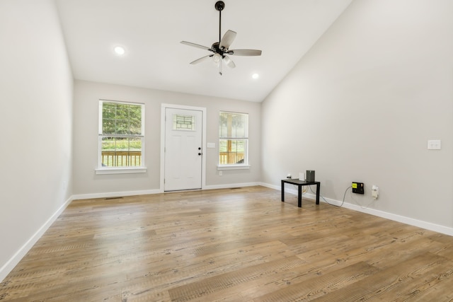 interior space with light hardwood / wood-style floors, lofted ceiling, plenty of natural light, and ceiling fan