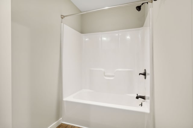 bathroom featuring hardwood / wood-style flooring and shower / bath combination