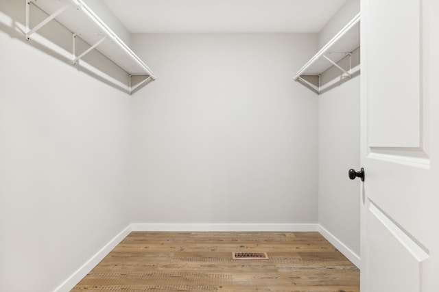 spacious closet with hardwood / wood-style floors