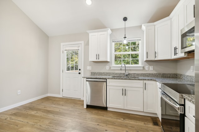 kitchen featuring appliances with stainless steel finishes, white cabinetry, sink, and plenty of natural light