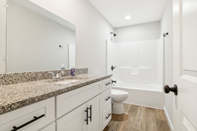 full bathroom with vanity, toilet, shower / tub combination, and hardwood / wood-style floors