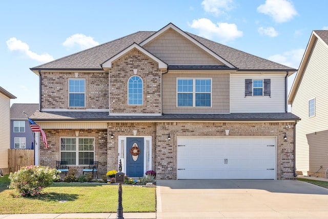 craftsman inspired home with a front yard and a garage