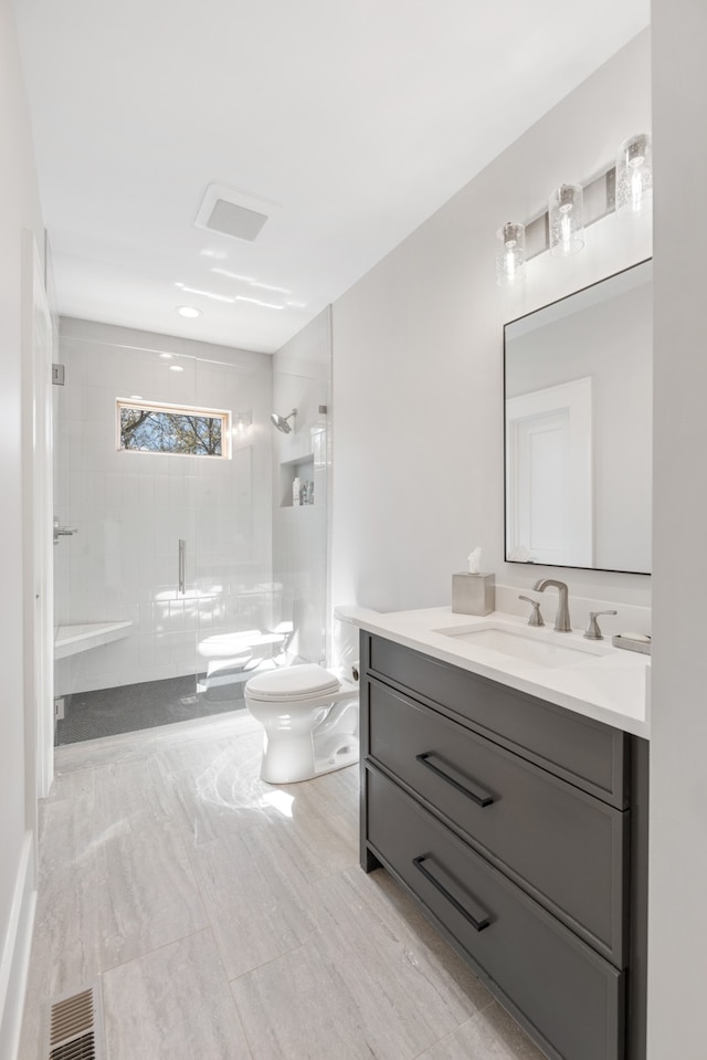 bathroom featuring toilet, a bidet, vanity, and a tile shower