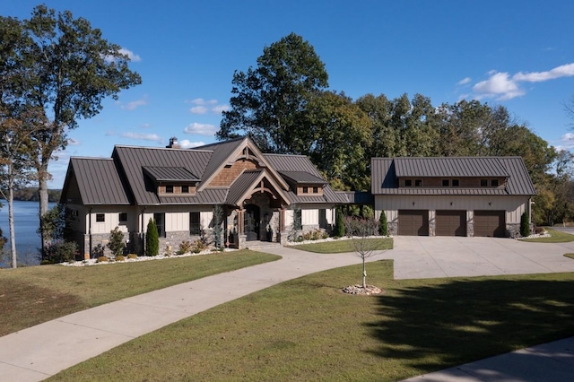 5893 Cairo Bend Rd, Lebanon, TN 37087 - modern farmhouse featuring a standing seam roof, stone siding, driveway, a garage, and a front yard